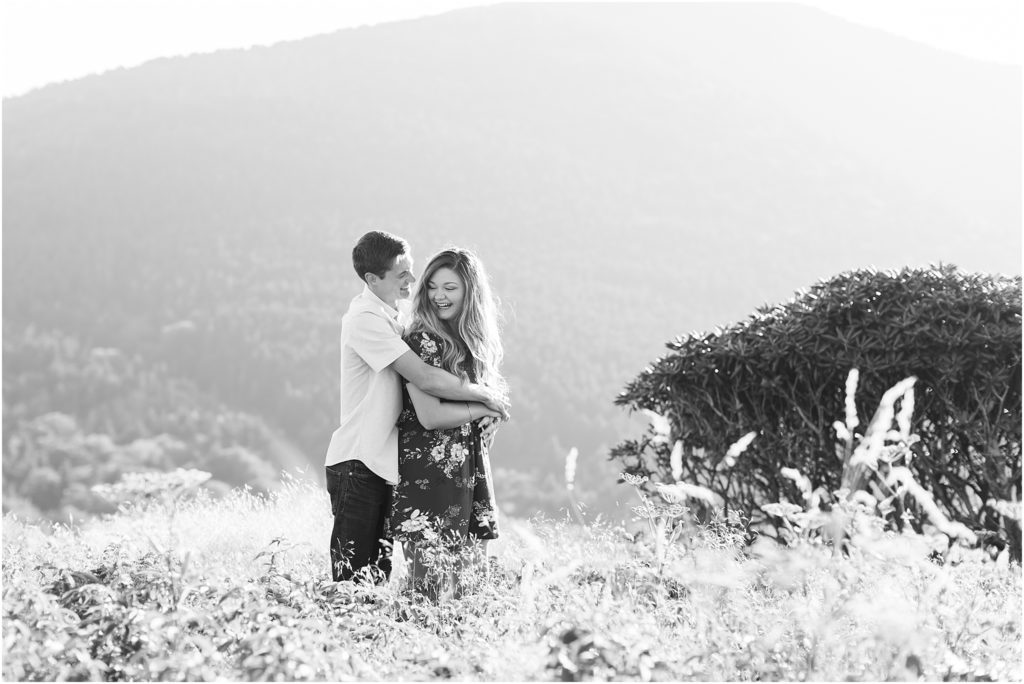 Couple in black and white snuggling in Carvers Gap in Roan Mountain TN