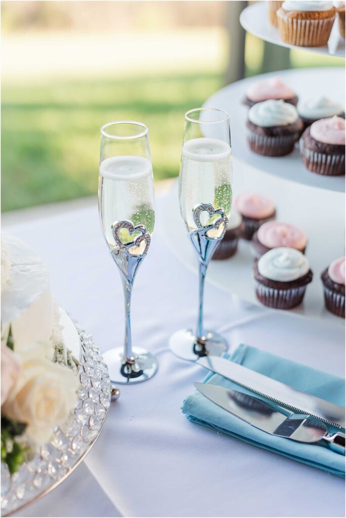 Several wedding details with champagne and cupcakes in focus at chateau selah reception wedding