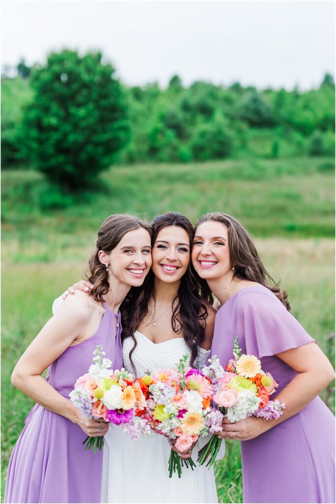 Bride smiling with bridesmaids at glade creek farm wedding venue