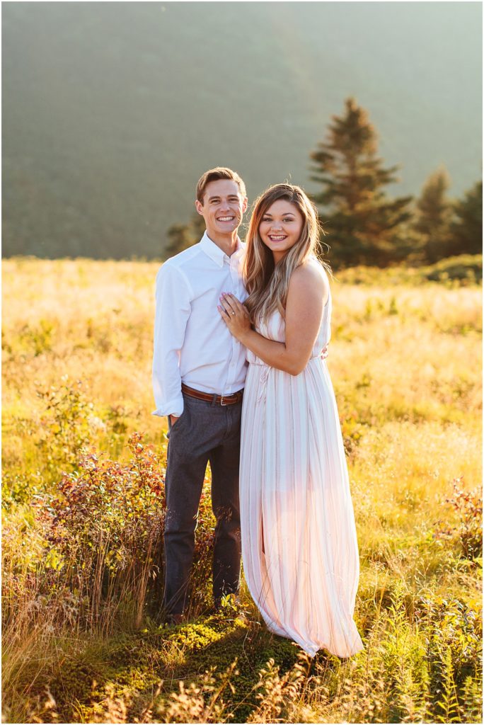 Couple Roan Mountain Engagement Session smiling at the bristol va wedding photographer during the Carvers Gap couple photos