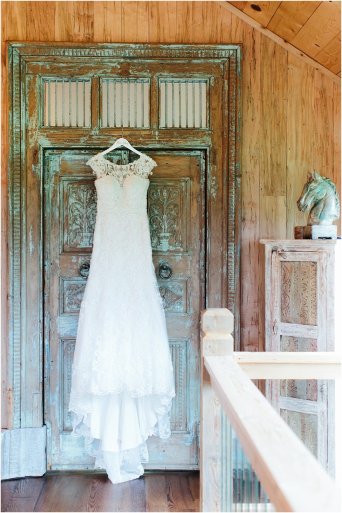 Brides dress hanging on door at Crooked River Farm Wedding Venue Hiltons VA