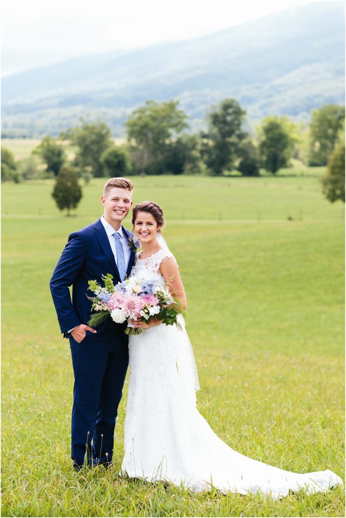 Bride and groom smiling in front of mountain at Crooked River Farm Hiltons, VA