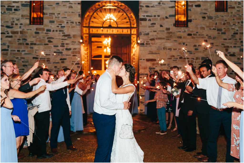 Bride and groom being greeted with sparklers as they exit their wedding reception