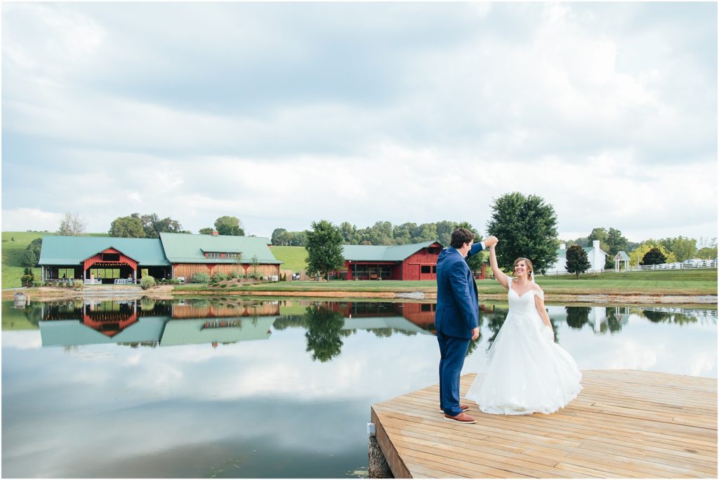 Couple twirling photo on bridge at Grace Meadows Farm wedding venue 