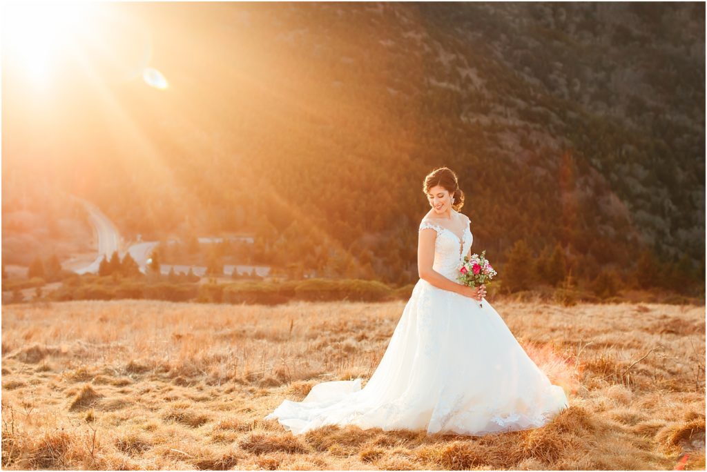 Wedding photography captures bride holding bouquet while sun is coming down over her shoulder Roan mountain state park wedding photos