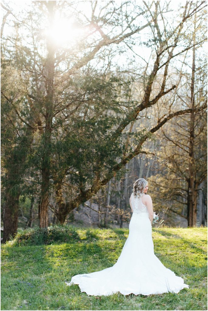 Bride glancing over her shoulder at edge of dress at Side Porch Wedding Venue with Bristol Virginia photographer