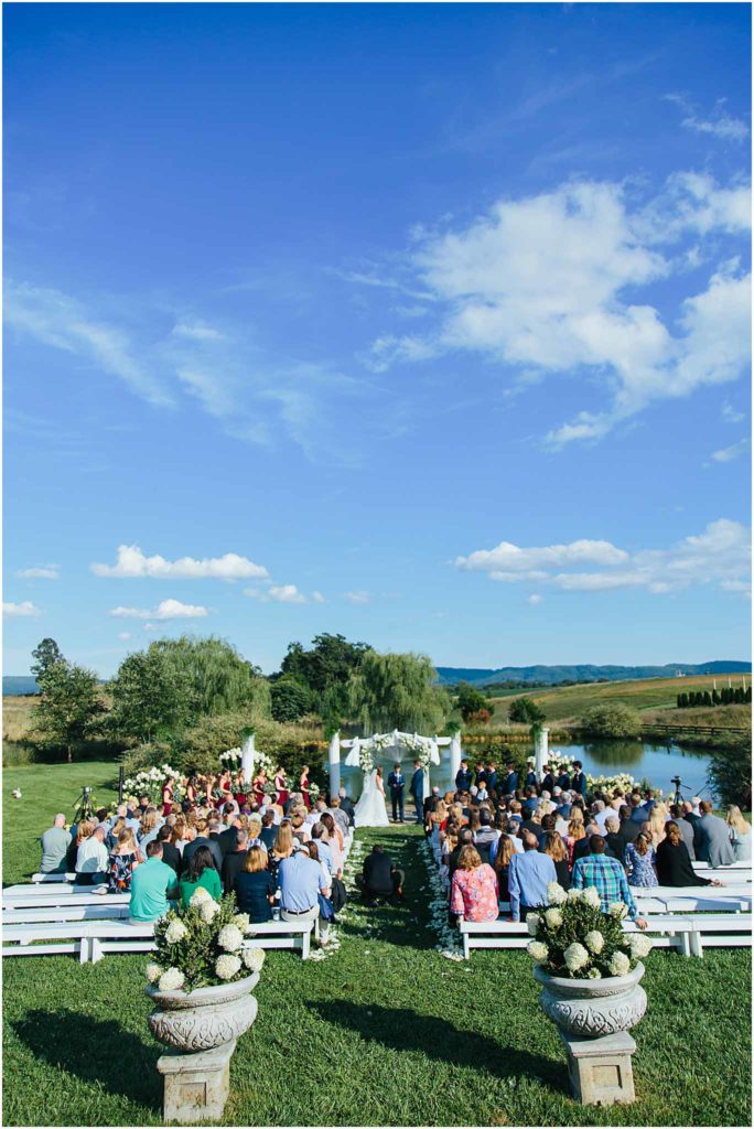 Wide angle of ceremony overlooking lake at Sinkland farms wedding venue
