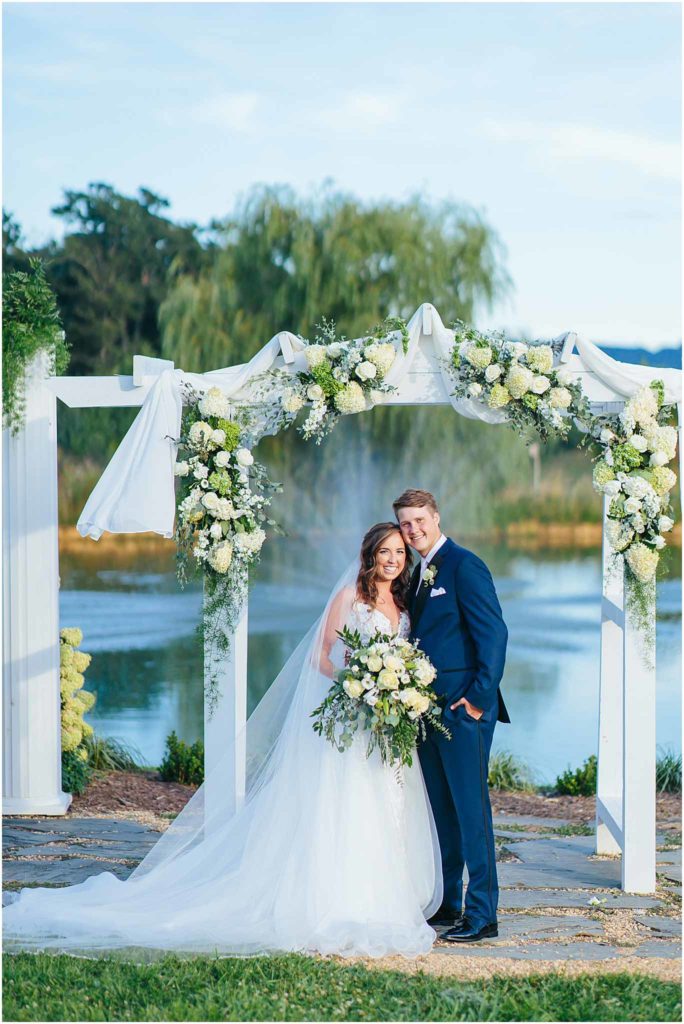Newly married couple in front of lake arbor sinkland farms wedding