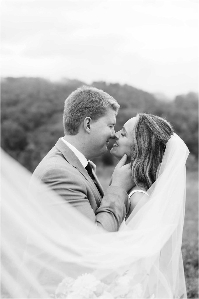 Close in veil in black and white groom holding brides neck at chateau selah venue