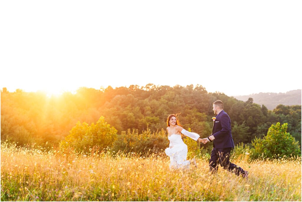 Bride leading Groom through field near Glade Creek Farm wedding venue